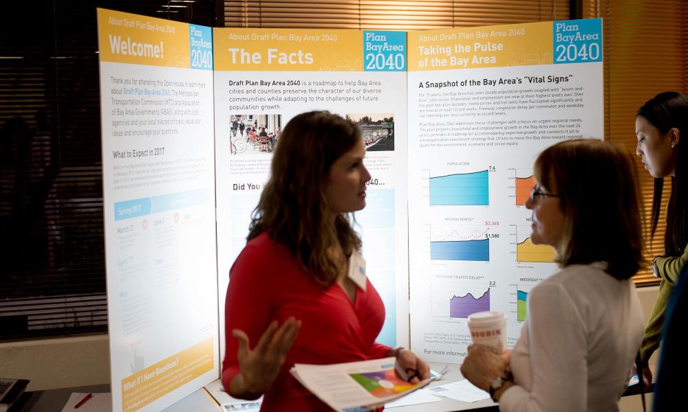 MTC staff member Georgia Gann Dohrmann speaks with a resident in Fremont at the Plan Bay Area 2040 open house for Alameda County.
