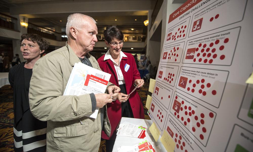 Attendee looks at an information display at the Plan Bay Area meeting in San Francisco at the Hotel Whitcomb, 6-14-16